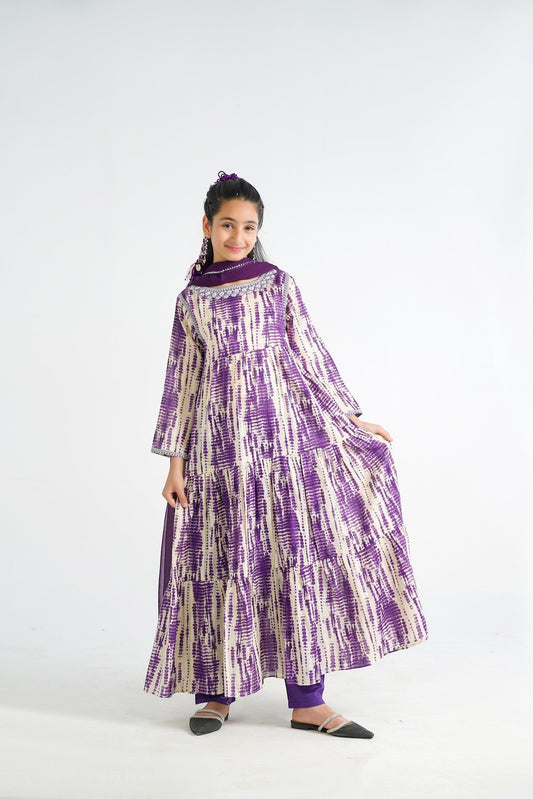 Lily tiered maxi dress in purple and cream tie-dye print, with matching scarf and trousers. Model is wearing a flowing, bohemian-style dress.