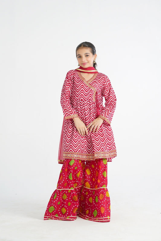 Lily red and white chevron angrakha kurta with embroidered hem and tassels, paired with printed gharara pants and dupatta.