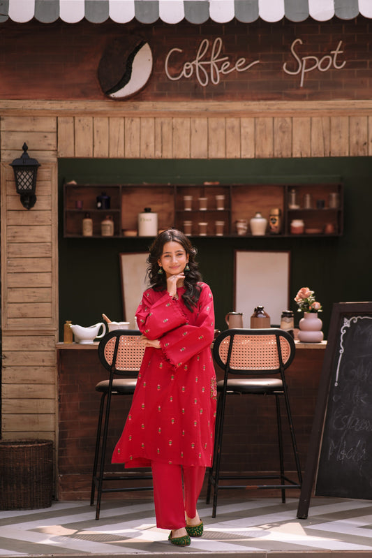 Lily deep red embroidered kurta and trouser set with wide sleeves and floral motifs worn by a woman in a cafe