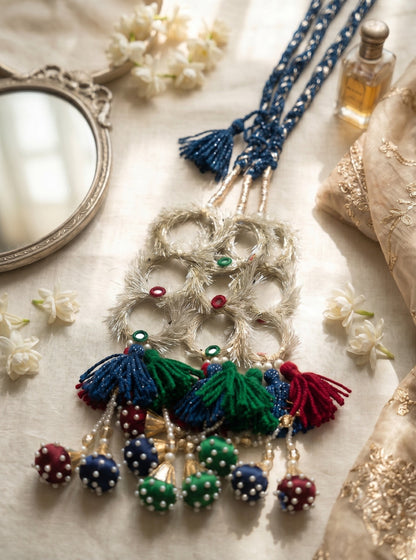 Lily Ruby Heer Paranda featuring a blue braided cord, silver mirror-work accents, and multi-colored tassel pom-poms.