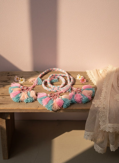 Lily handcrafted boho necklace with pink, blue, and peach tassels and mirrored accents on a braided cord.
